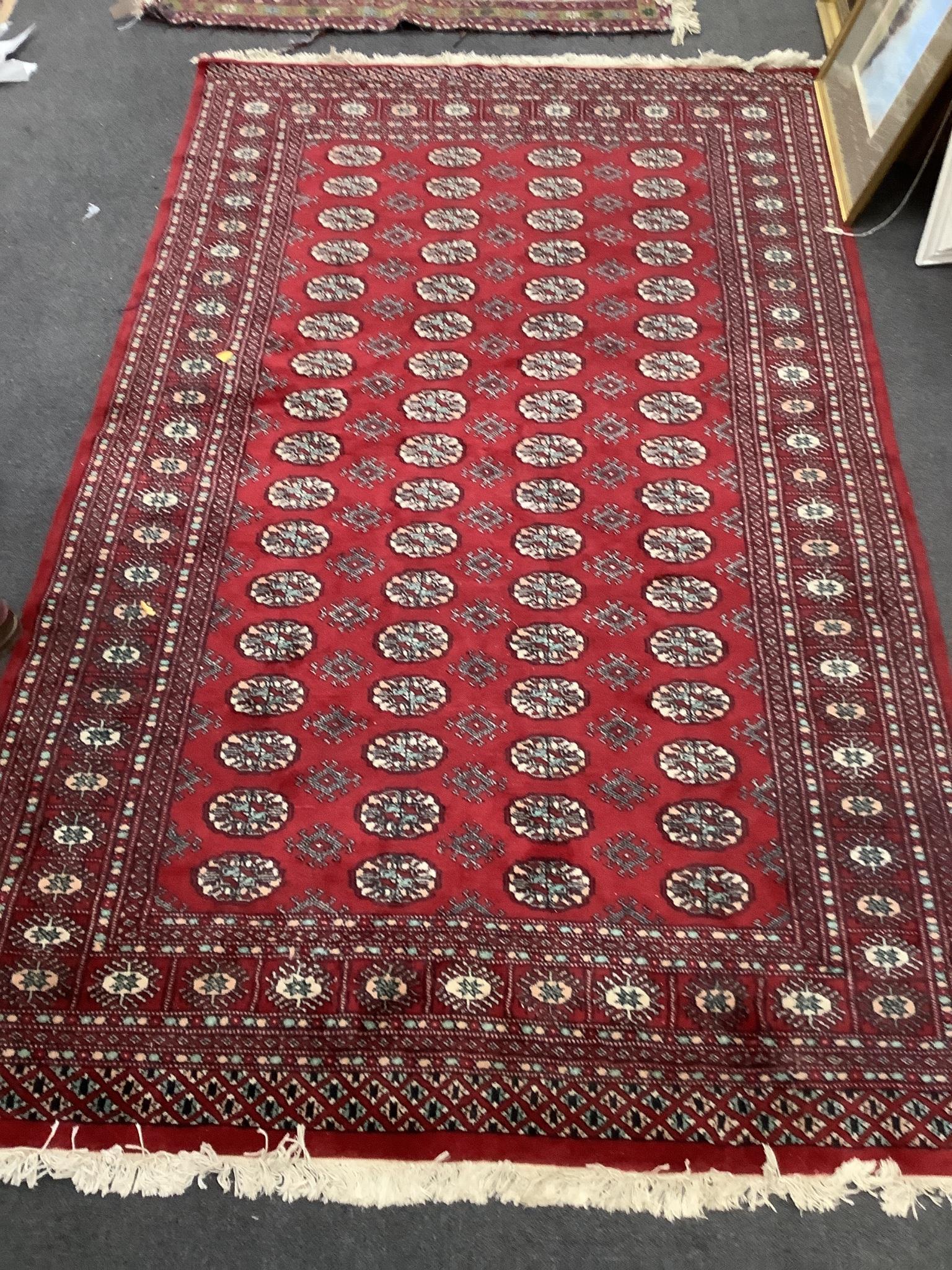 A Bokhara red ground rug, 246 x 152cm